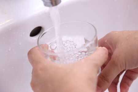Filling water into the glasses.