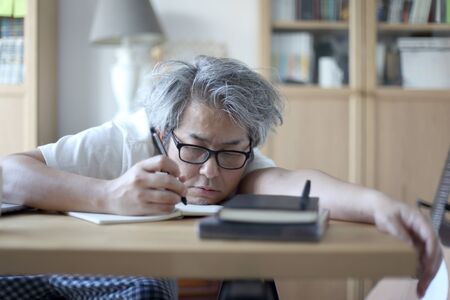 The Asian man working in his home studio.の写真素材