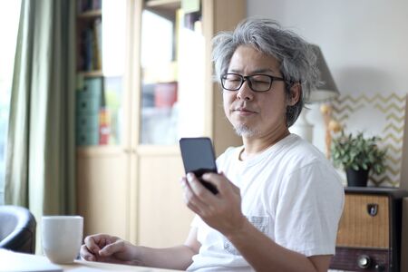The Asian man working in his home studio.の写真素材