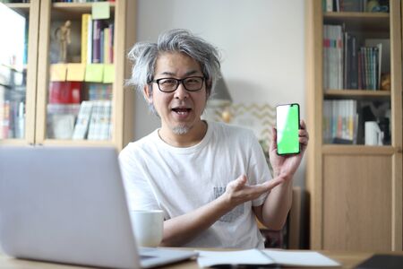 The Asian man working in his home studio.の写真素材
