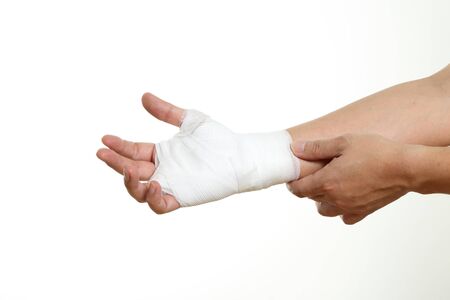 Human's hand with bandage on the white background.