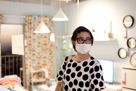 The Asian woman going shopping with face mask.の写真素材