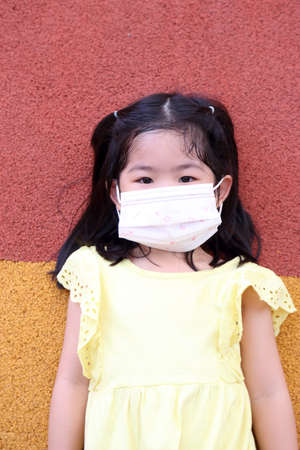 The cute Asian girl with cover mask.