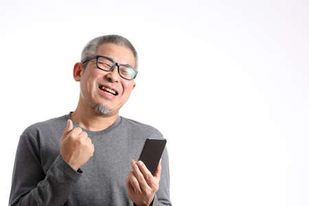 The Asian man with buzz standing on the white background.