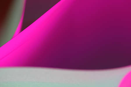 The abstract picture of curved paper in vivid colours.
