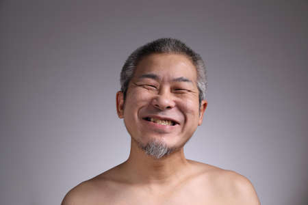 The Portrait of Asian man on the grey background.の写真素材