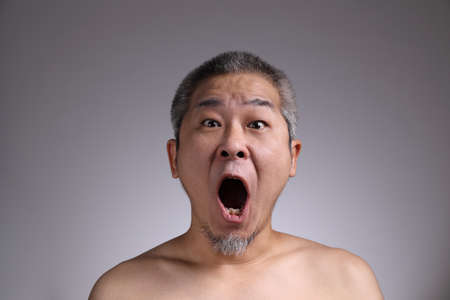 The Portrait of Asian man on the grey background.の写真素材