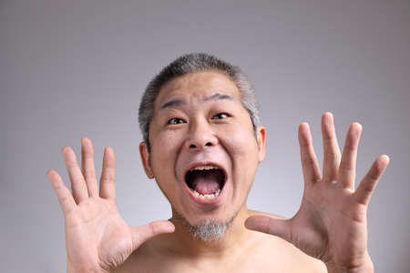 The Portrait of Asian man on the grey background.