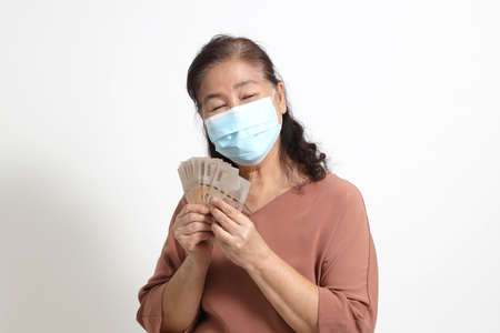 The Asian elder femaleon the white background.の写真素材