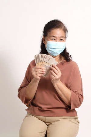 The Asian elder femaleon the white background.の写真素材