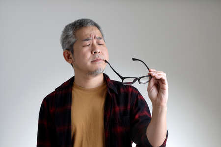 The Asian man standing on the white background.の写真素材