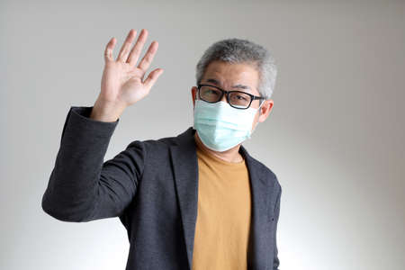 The Asian man in smart casual standing on the white background.の写真素材