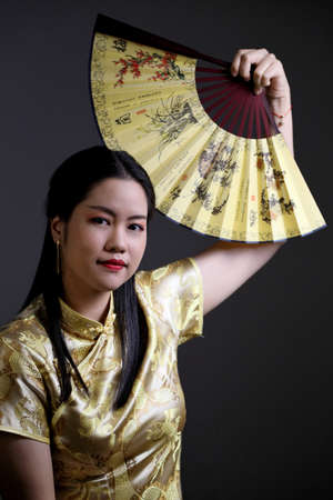 The Asian woman in vintage Chinese clothes.