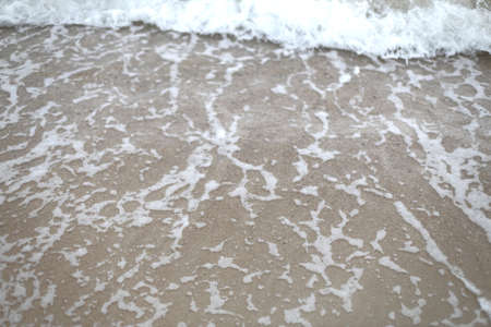 The ocean wave moving on the beach.の写真素材