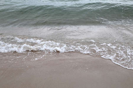 The ocean wave moving on the beach.