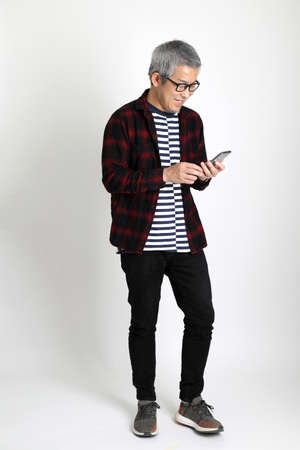 The Asian man standing on the white background