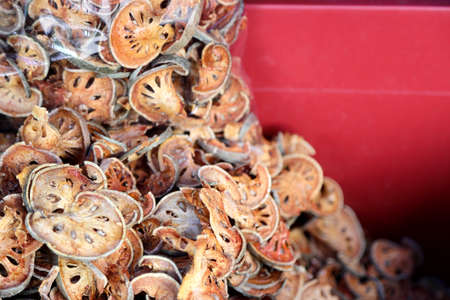 The dried bael onthe tray for sale in Thai market.の写真素材