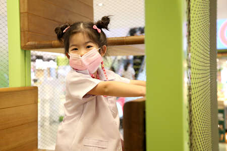 The Asian kid feels happy in public playground.の写真素材