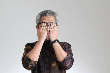 The senior Asian man standing on the white backgroundの写真素材