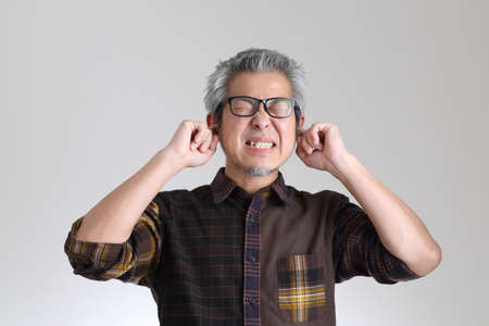 The senior Asian man standing on the white backgroundの写真素材