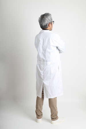 The senior Asian physician on the white background.の写真素材