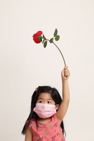 The Asian girl holding big flower on the white background.の写真素材