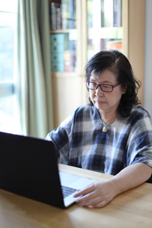 The senior Asian woman using laptop.の写真素材
