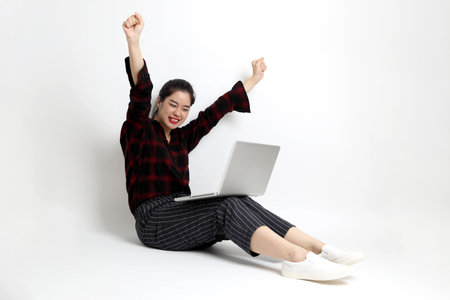 The young Asian woman with casual clothes on the white background.