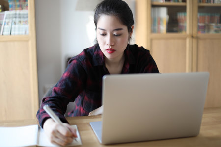 The Asian woman working from home.