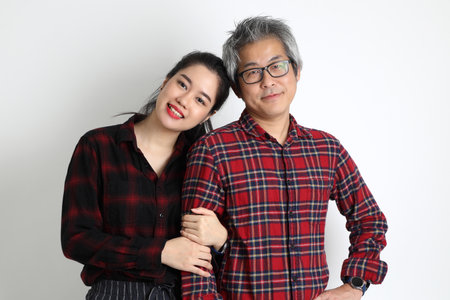 The Asian couple with different ages standing on the white background.の写真素材