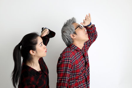The Asian couple with different ages standing on the white background.の写真素材