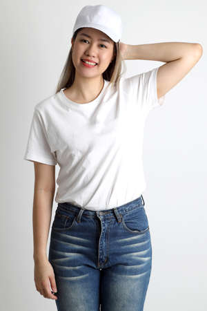 The young Asian woman posing on the white background.の写真素材