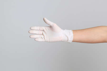 The human hand with glove on the white backgroundの写真素材