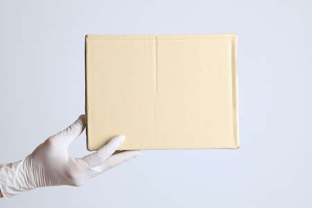 The human hand with glove on the white backgroundの写真素材