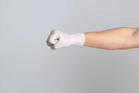 The human hand with glove on the white backgroundの写真素材