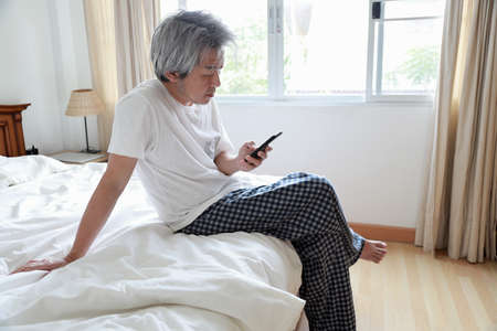 The senior Asian man in the bedroom.の写真素材