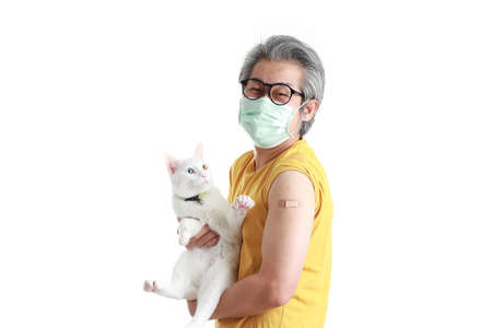 The senior Asian man with mask showing plaster on his shoulder.