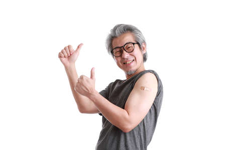 The senior Asian man showing plaster on his shoulder.