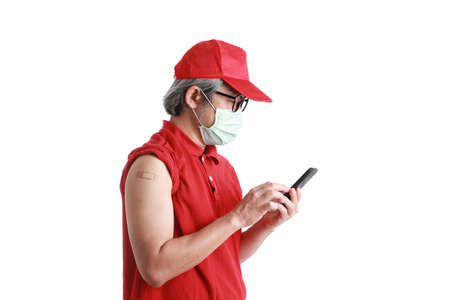 The  Asian messenger with plaster on his shoulder standing on the white background.