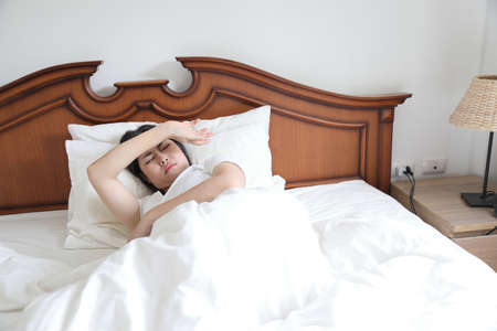 The Asian woman relaxing on the bed.の写真素材