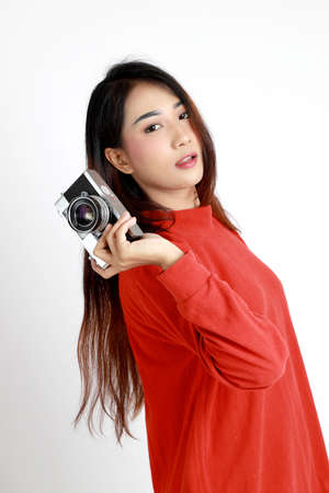 The Asian womna standing on the white background.の写真素材
