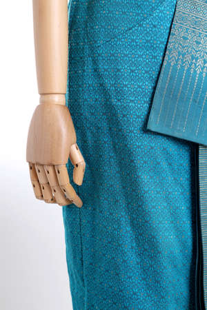 The woman mannequin wearing Thai dressed on the white background.の写真素材