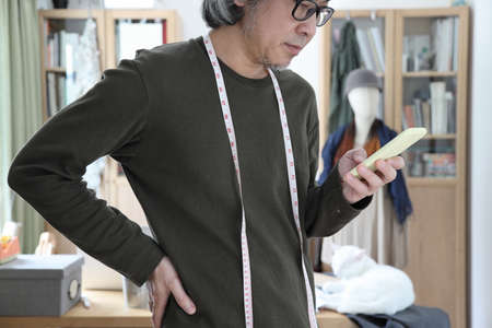 The senior Asian designer working in the studio.の写真素材