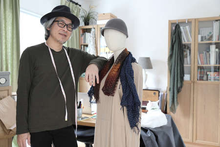 The senior Asian designer working in the studio.の写真素材