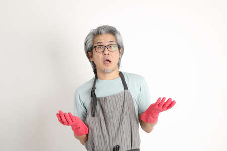 The senior Asian housekeeper standing on the white background.の写真素材