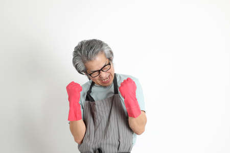 The senior Asian housekeeper standing on the white background.の写真素材