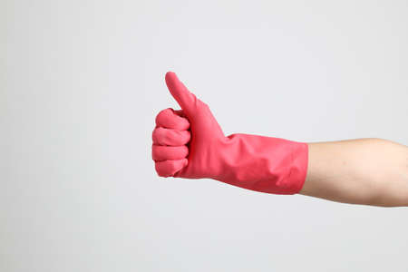 The pink gloves on the white background.の写真素材