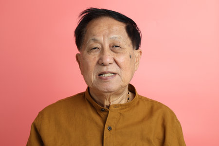 The senior Asian man portrait with no retouched skin in the pink background.の写真素材