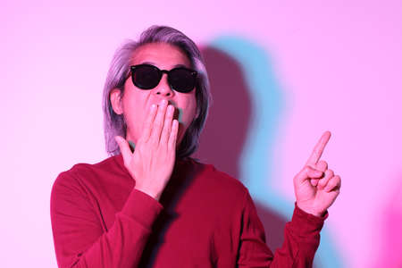The cool senior Asian man in the gel color light photography.