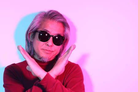 The cool senior Asian man in the gel color light photography.